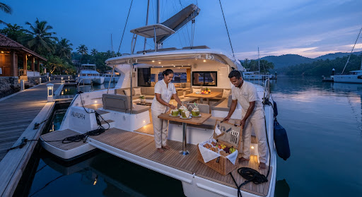 A whale-watching boat in a tropical harbour in Sri Lanka at early morning blue dawn
